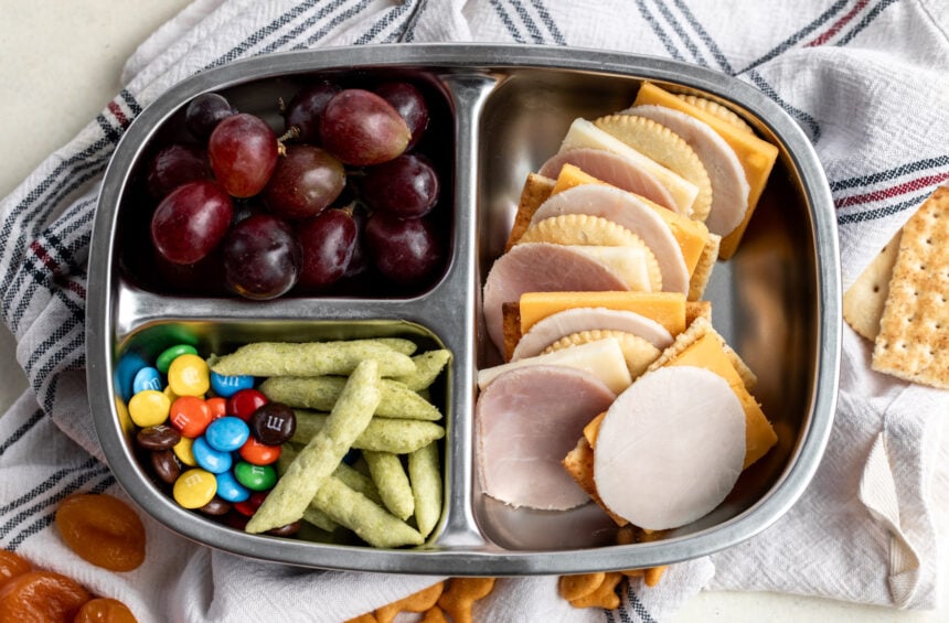 homemade lunchables with cheese and crackers in bento box.