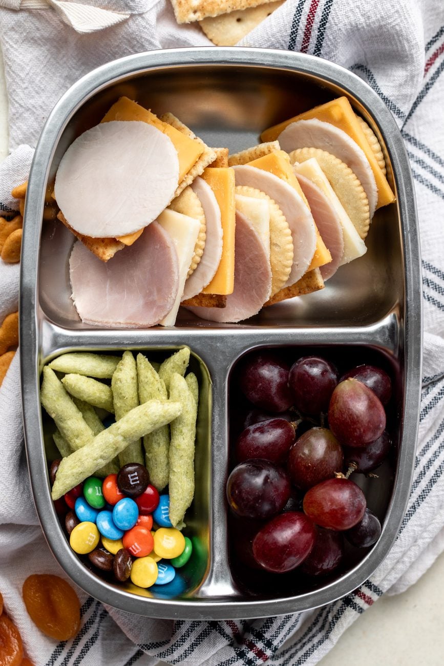 homemade lunchables with cheese and crackers in bento box.