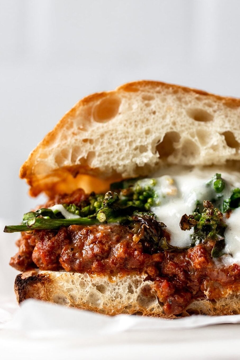 Italian Sloppy Joe Sandwich made with bolognese, rapini and burrata on ciabatta bread.