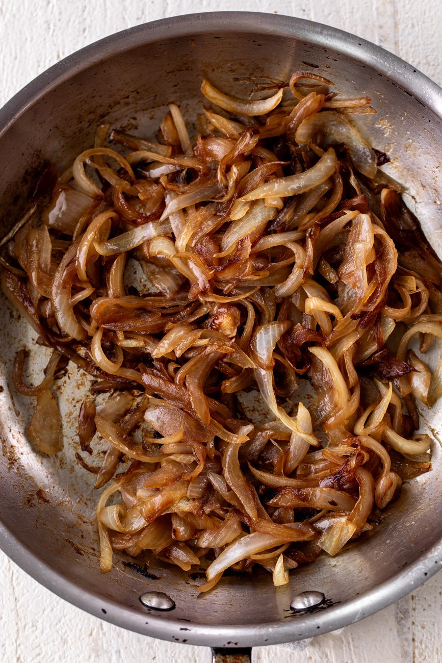 caramelized sliced onions in sauté pan.