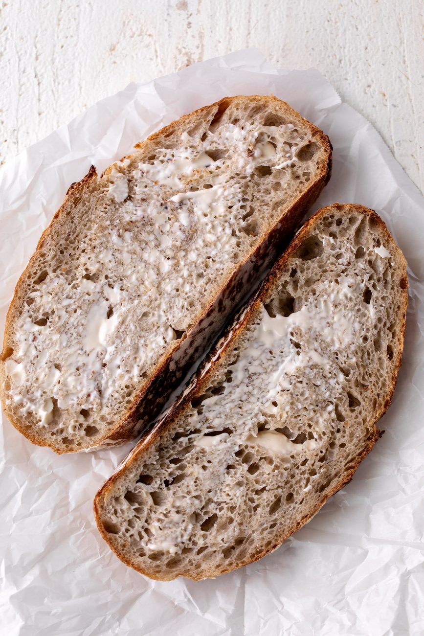 sliced of sourdough bread spread with mayonnaise.